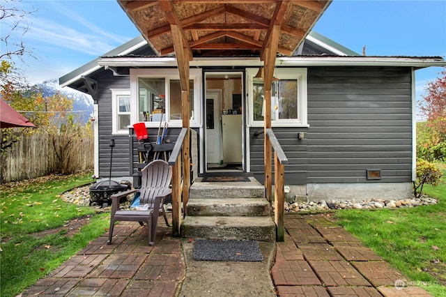 entrance to property featuring a yard