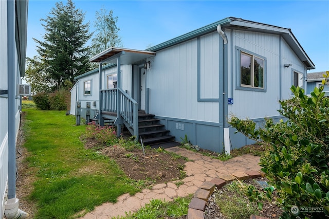 view of side of home featuring a yard