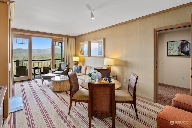 carpeted living room with a mountain view and ornamental molding