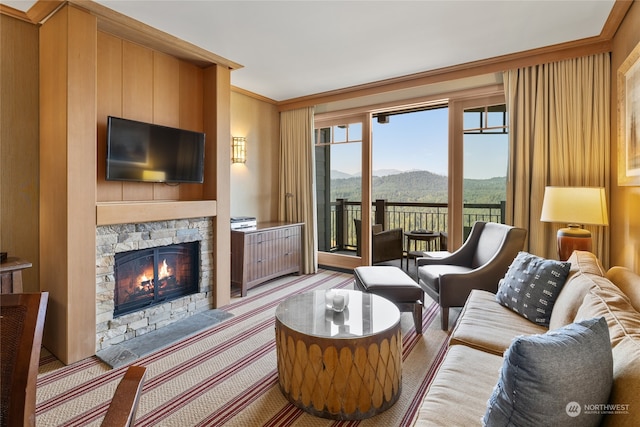 living room with a stone fireplace, crown molding, and light colored carpet