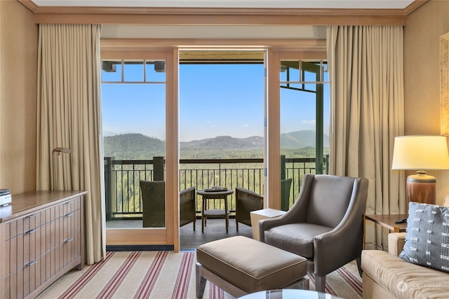 living area with a mountain view, a wealth of natural light, and carpet floors