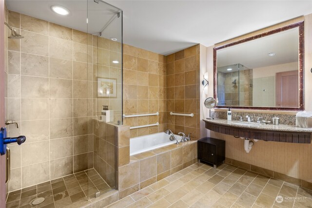 bathroom featuring independent shower and bath, tile walls, and tile patterned flooring