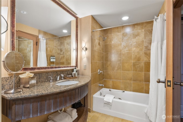 bathroom with tile walls, tile patterned flooring, vanity, and shower / bath combination with curtain