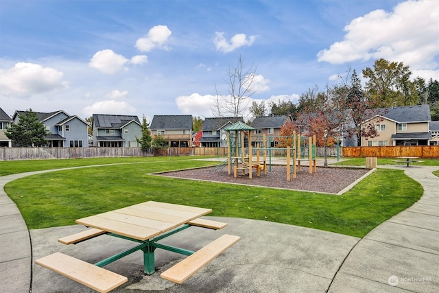 view of playground with a lawn