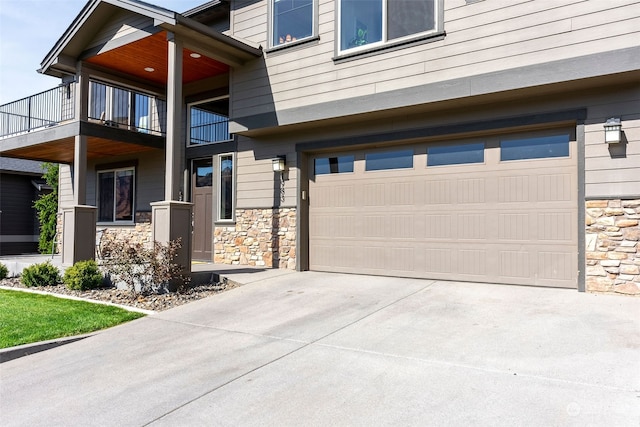 view of front of home with a balcony and a garage