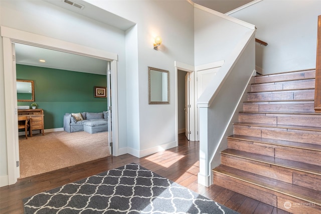 staircase with hardwood / wood-style floors