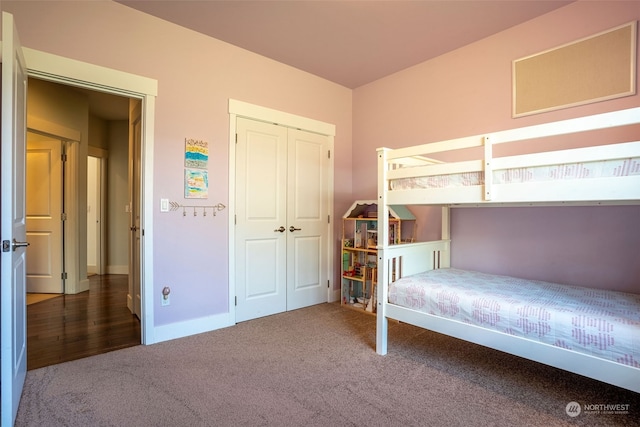 unfurnished bedroom featuring dark colored carpet and a closet