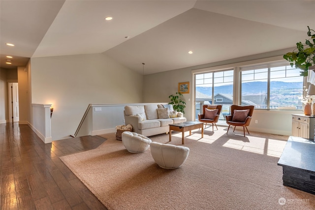 living room featuring vaulted ceiling, hardwood / wood-style flooring, and a mountain view