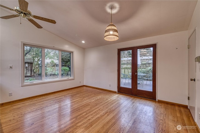 unfurnished room with lofted ceiling, light wood finished floors, plenty of natural light, and french doors