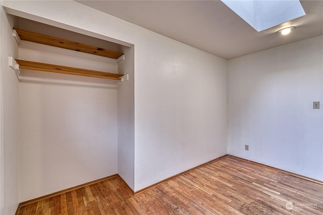 interior space featuring a skylight and light wood finished floors