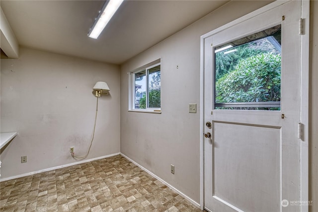 doorway to outside with baseboards