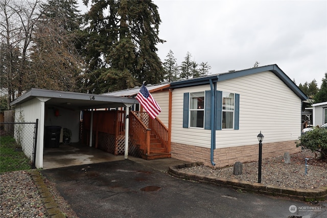 view of front of property featuring a carport