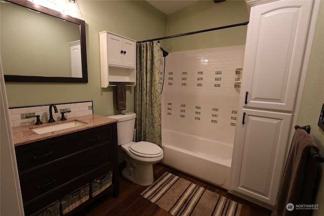 full bathroom with hardwood / wood-style flooring, tasteful backsplash, shower / bath combo with shower curtain, vanity, and toilet