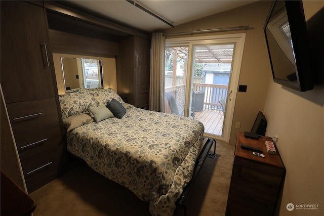 carpeted bedroom with vaulted ceiling and access to outside