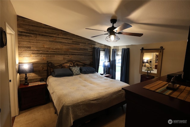 bedroom with wooden walls, vaulted ceiling, light carpet, and ceiling fan