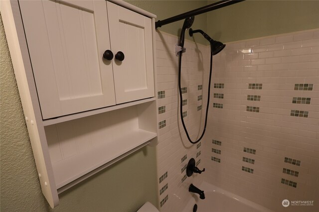 interior space featuring tiled shower / bath combo