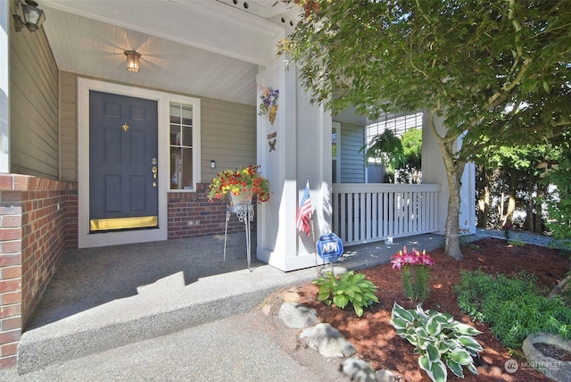 doorway to property featuring covered porch