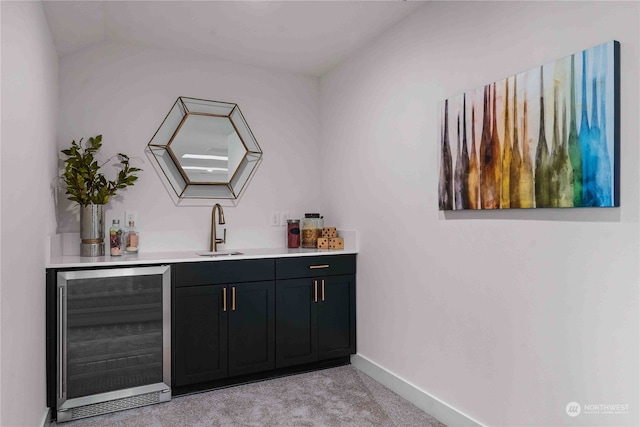 bar featuring wine cooler, sink, light carpet, and vaulted ceiling