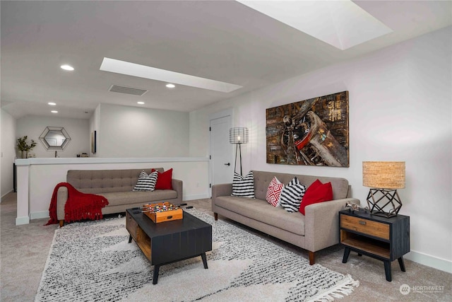 carpeted living room with a skylight