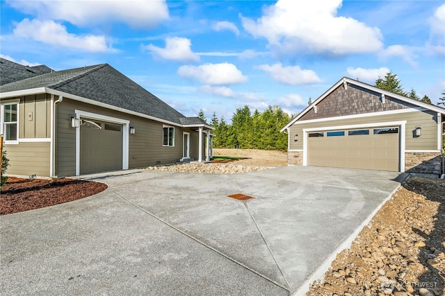 25709 64th Avenue Ct E Unit 7, Graham, WA 98338 - view of side of property featuring roof with shingles, stone siding, and concrete driveway