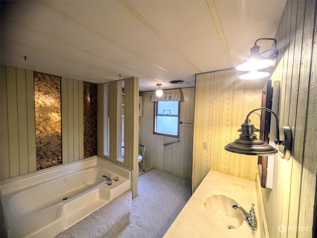 bathroom with a bathing tub, vanity, and toilet