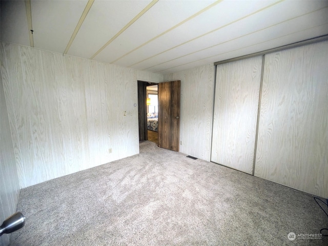 unfurnished bedroom with carpet floors and a closet