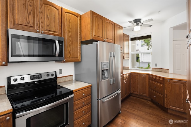 kitchen featuring stainless steel appliances, dark wood-type flooring, and ceiling fan