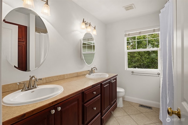 bathroom with vanity, toilet, and tile patterned flooring