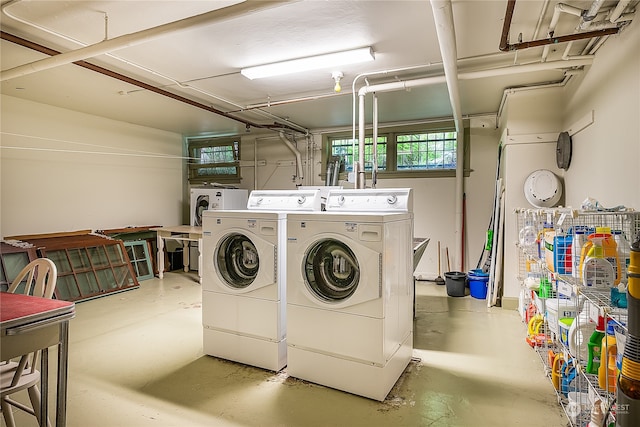 clothes washing area with separate washer and dryer