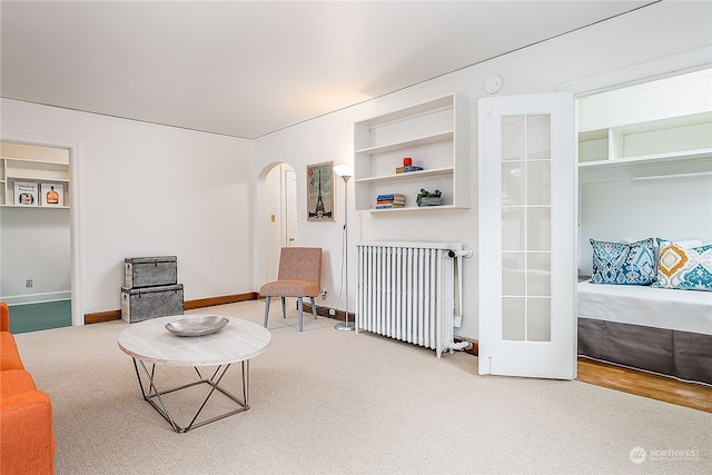 sitting room with radiator and hardwood / wood-style floors