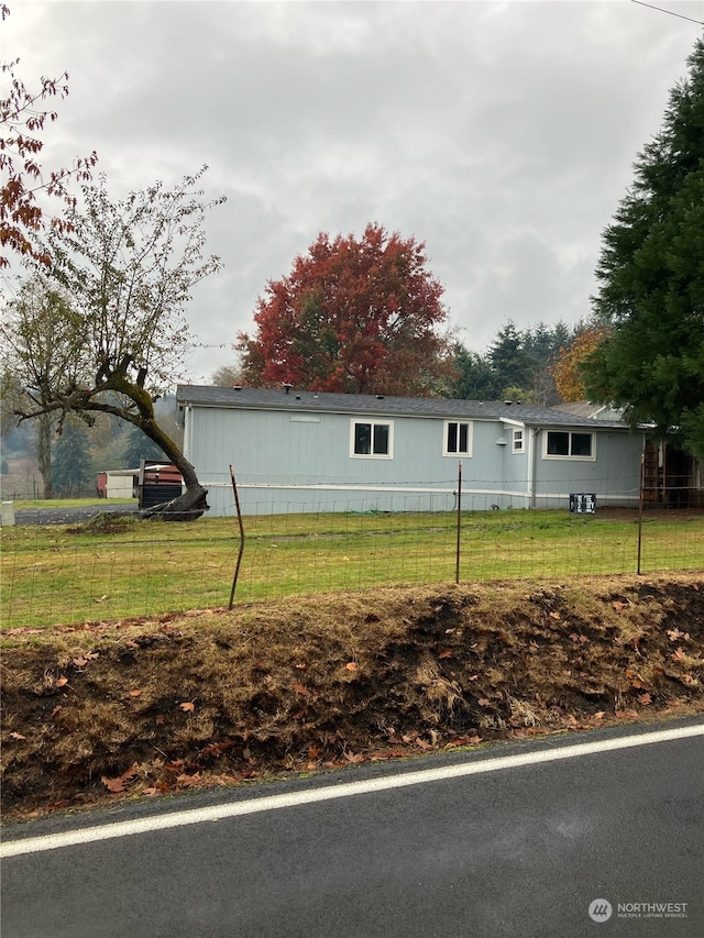 view of side of home featuring a lawn