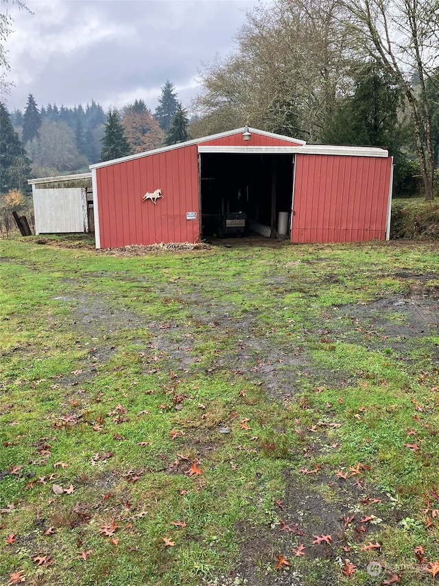 view of outbuilding with a yard