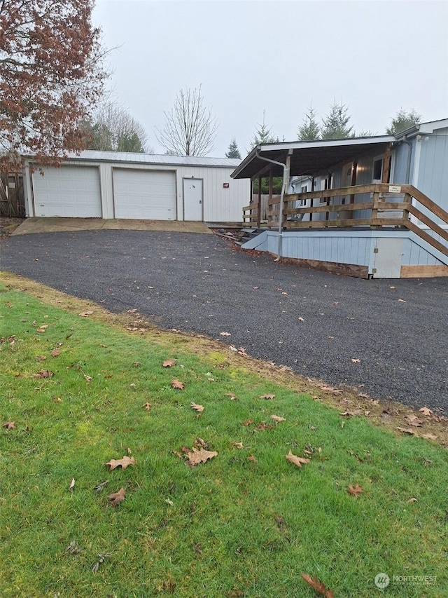 view of front of house with a garage and an outdoor structure