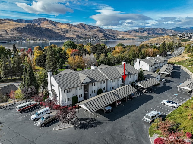 drone / aerial view with a water and mountain view