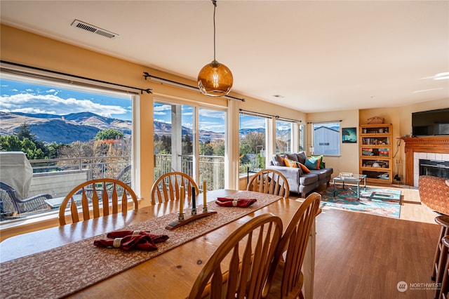 dining space featuring hardwood / wood-style flooring and a fireplace