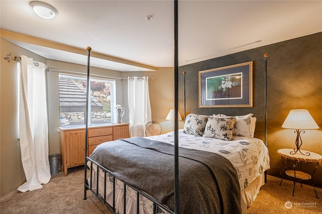 bedroom featuring light carpet and baseboards