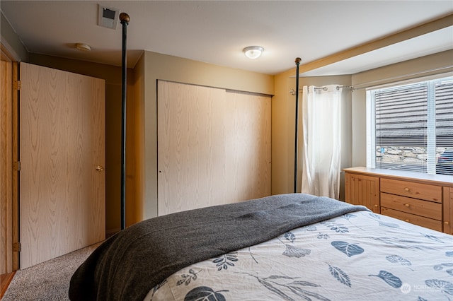 carpeted bedroom with a closet