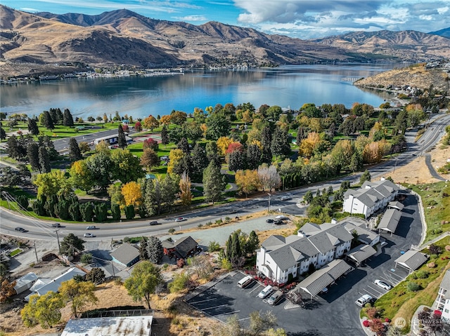 birds eye view of property with a water and mountain view