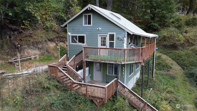 rear view of house featuring a deck