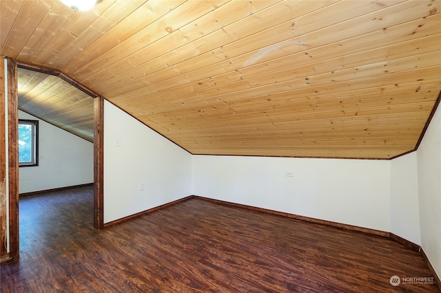 additional living space featuring dark wood-type flooring, vaulted ceiling, and wood ceiling