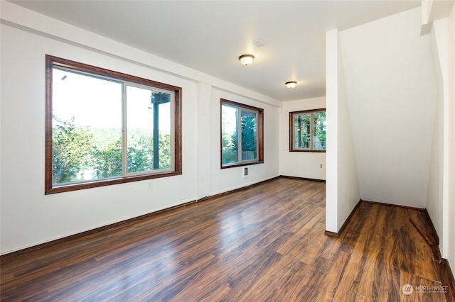 unfurnished room featuring dark hardwood / wood-style flooring