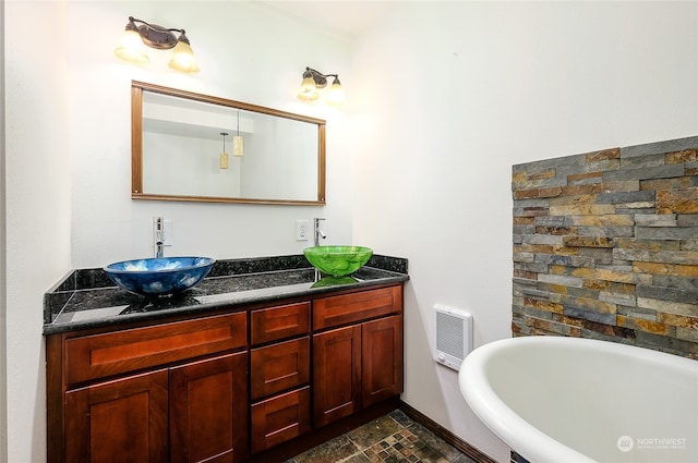 bathroom featuring vanity, heating unit, and a bathing tub