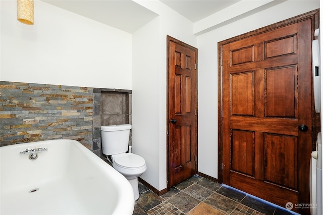 bathroom with tile walls, toilet, and a tub