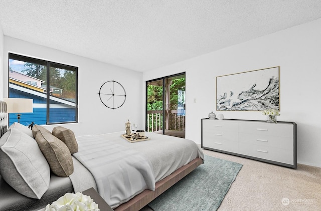 carpeted bedroom featuring access to outside and a textured ceiling