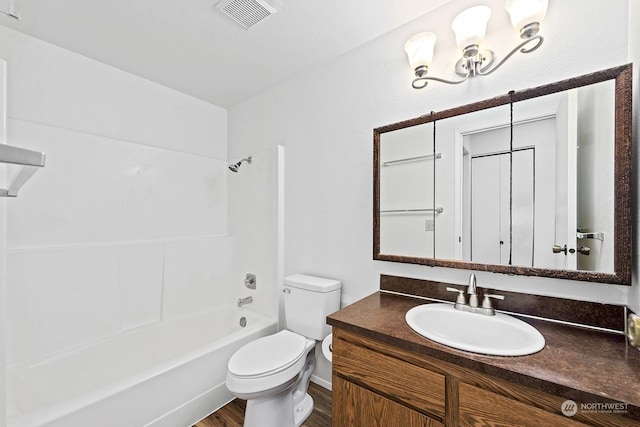 full bathroom featuring vanity, hardwood / wood-style floors, shower / tub combination, and toilet