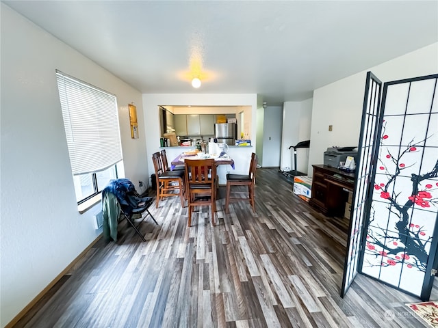 dining space with wood-type flooring