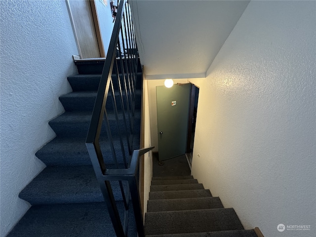 stairway with lofted ceiling