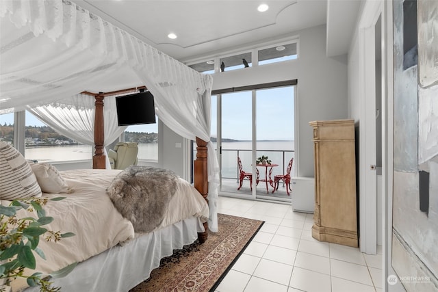 bedroom featuring access to exterior, multiple windows, and light tile patterned floors