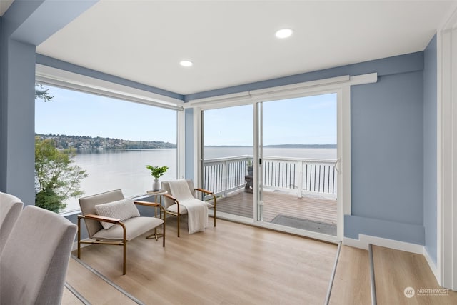 sunroom / solarium with a water view