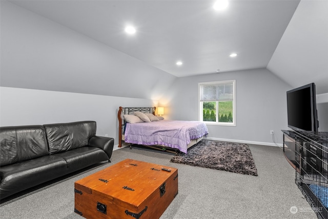 carpeted bedroom with lofted ceiling